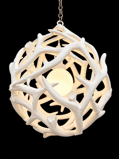 White antler ball chandelier hanging from chain, angled view - Rocky Mountain Antler Works