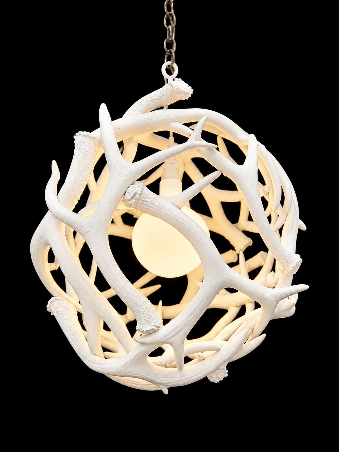 White antler ball chandelier, side view with warm lit interior - Rocky Mountain Antler Works